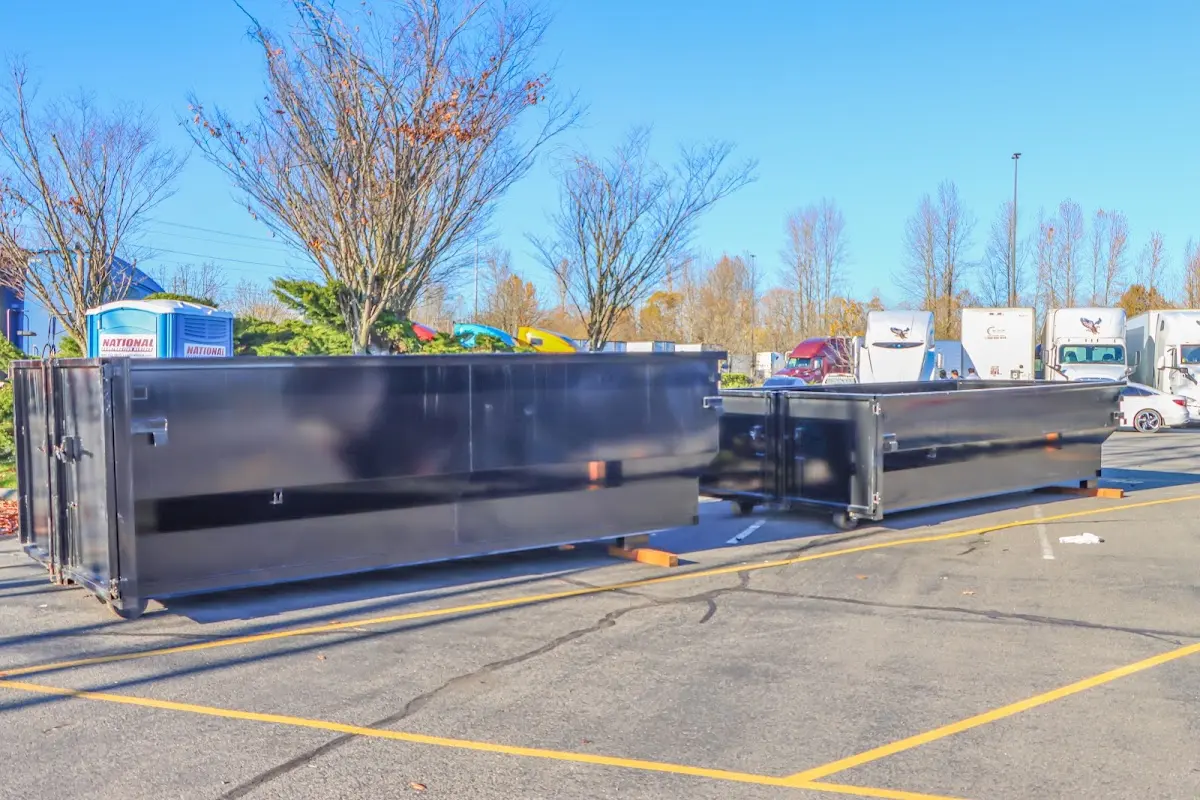 Professional dumpster rental service with roll-off container on residential driveway in Mount Vista